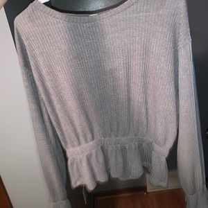very cute long sleeve that bunches in the sleeves and bottom. fits like a medium
